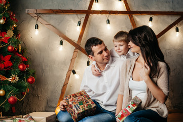 happy young family in Christmas decorations