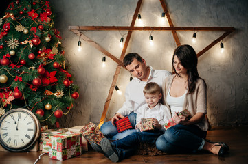 Obraz na płótnie Canvas happy young family in Christmas decorations