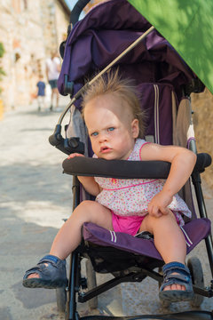 Adorable little baby girl in a stroller