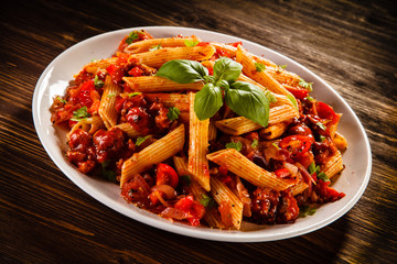 Penne with meat, tomato sauce and vegetables
