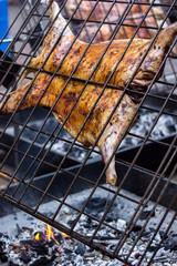 Appetizing grilled lamb on the spit. Roasted pig on traditional barbecue. Roasting barbecue is prepared of a ram pig baked pork meat Street food Whole carcass pig roasting on the grill over charcoal.
