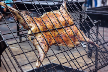 Appetizing grilled lamb on the spit. Roasted pig on traditional barbecue. Roasting barbecue is prepared of a ram pig baked pork meat Street food Whole carcass pig roasting on the grill over charcoal.