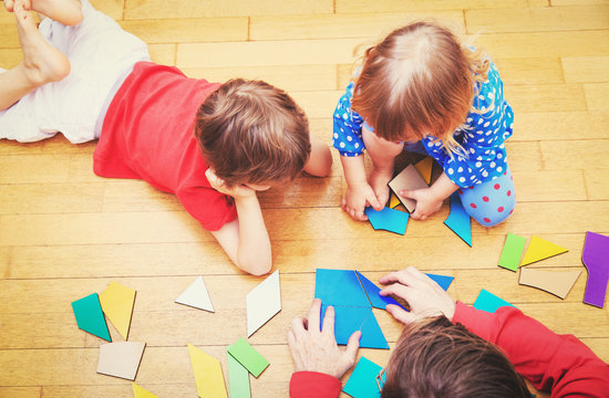 Teacher And Kids Playing With Geometric Shapes