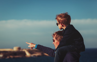 father and little son on shoulders travel in Europe