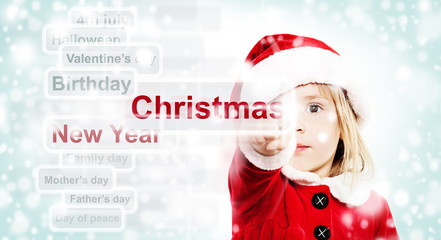 Christmas Child in Red Santa Hat Ponting to Christmas