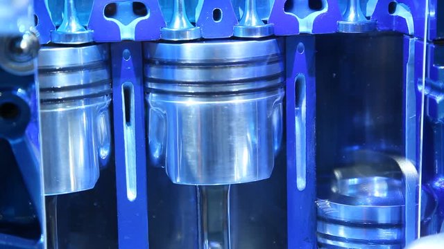 Cross section of a working combustion engine with pistons moving up and down