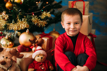 Portrait of adorable boy with giftboxes