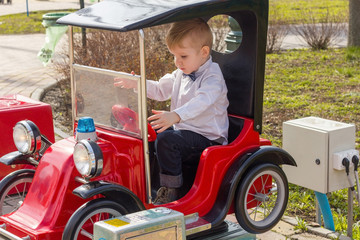 Fototapeta na wymiar Little boy is riding the car
