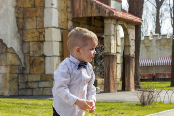 Boy in shirt is playing in park