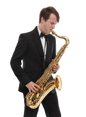 Fototapeta premium Saxophonist in a tuxedo plays music on sax.