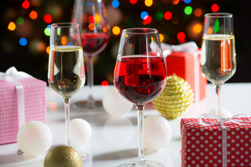 Glasses of wine and christmas gifts