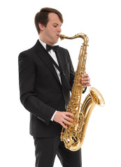Fototapeta premium Saxophonist in a tuxedo plays music on sax.