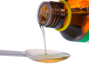 Bottle pouring Medicine Syrup in Dose Spoon - 125601693