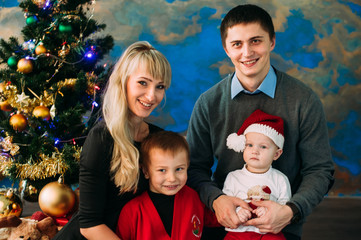 Portrait of friendly family looking at camera on Christmas evening