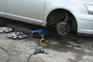 Fototapeta premium tire, the car on the jack, replacement of rubber, shallow dof