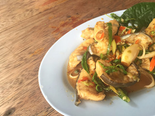 horizontal photo of fried spicy Mekong giant catfish with herb 
