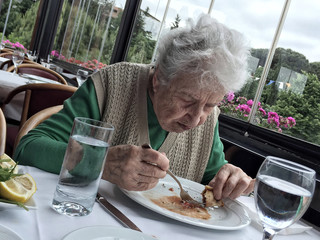 senior woman having lunch in a restaurant