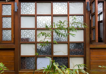 Wall with waving pattern in typical Chinese style with bamboo in
