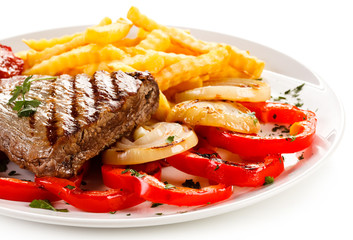 Grilled steak, French fries and vegetables 