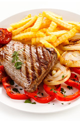 Grilled steak, French fries and vegetables 