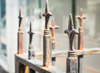 Metal fence at cemetery / Selective focus and color retro filter (graveyard, religion, faithful)