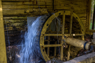 Working watermill wheel with falling water in the village in Voronezh Region