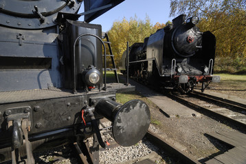 Obraz premium Old Vintage Steam Locomotive At The Train Depot 