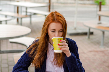 Young red woman with hot coffee