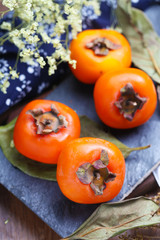persimmons on stone board