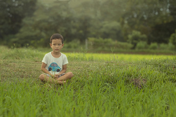 The little boy meditating but not focus on the activities becaus