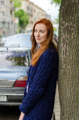 Young red woman walking in the city