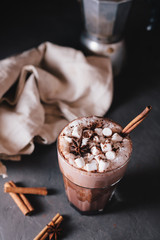 Cocoa or latte or hot chocolate with marshmallow and flavored with cinnamon. On a gray concrete background. Christmas present. Christmas concept. Christmas holiday.