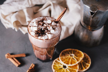 Cocoa or latte or hot chocolate with marshmallow and flavored with cinnamon. On a gray concrete background. Christmas present. Christmas concept. Christmas holiday.