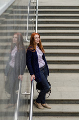 Young red woman walking in the city