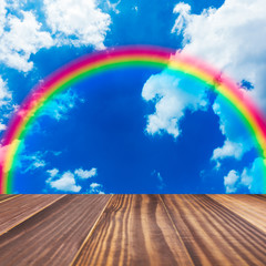 wooden floor with beautiful rainbow in blue light sky