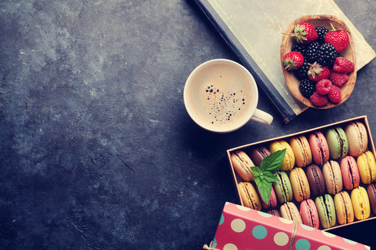 Colorful macaroons, berries and coffee