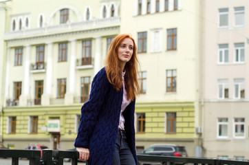 Fototapeta na wymiar Young red woman walking in the city