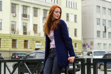 Young red woman walking in the city