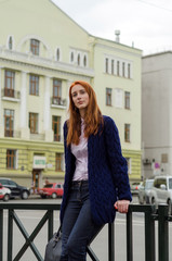 Young red woman walking in the city