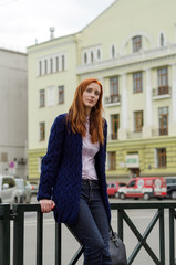 Young red woman walking in the city