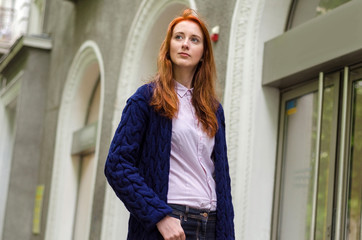 Fototapeta premium Young red woman walking in the city