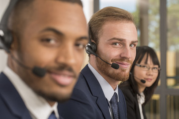 Portrait of young man working in a call center