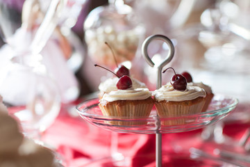 Cherry cupcakes on a cake stand, selective focus