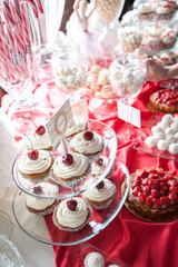 Naklejka premium Cherry cupcakes on a cake stand, selective focus