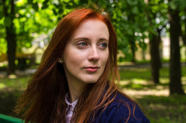 Naklejka premium Young red woman walking in the city