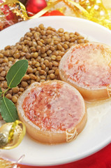 Italian cotechino with lentils on christmas table
