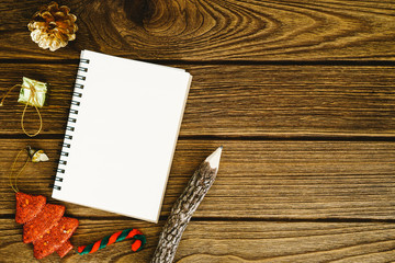 empty white space notebook with pencil and christmas ornament on