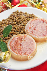 Italian cotechino with lentils on christmas table
