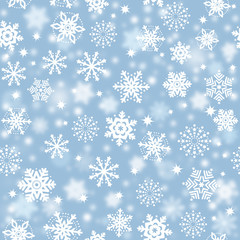 Snowflakes on blue sky, snowstorm - Christmas seamless background 