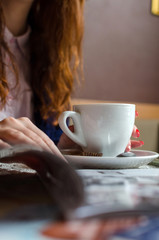 Young red woman with hot coffee